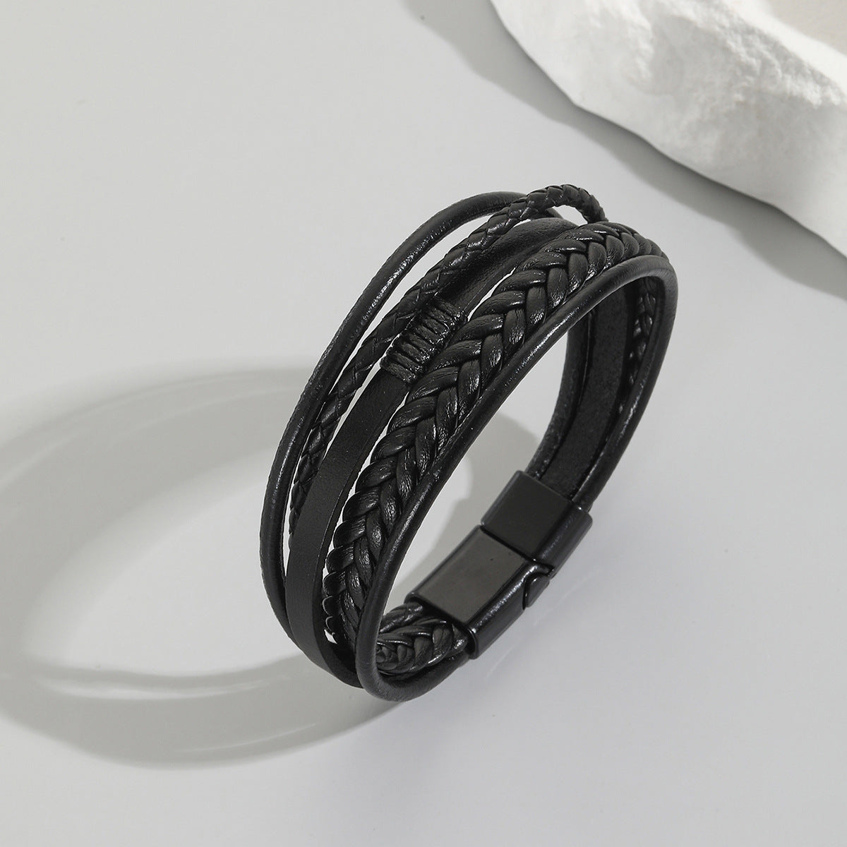 Multi-Strand Braided PU Leather Men's Bracelet in black with herringbone braid and magnetic clasp on grey background.